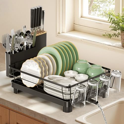 Black three-section counter dish rack with cup holder and utensil caddy — the drain outlet that routes water into the sink