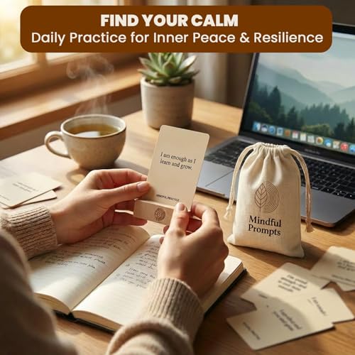 Hands holding a mindfulness card above an open journal and desk