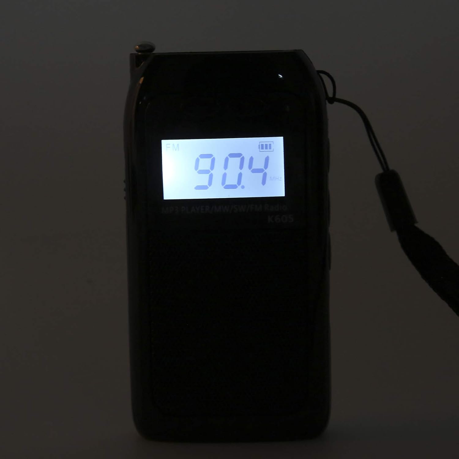 Heayzoki K605 Portable Radio with included accessories: USB charging cable, earphones, and a small pouch.