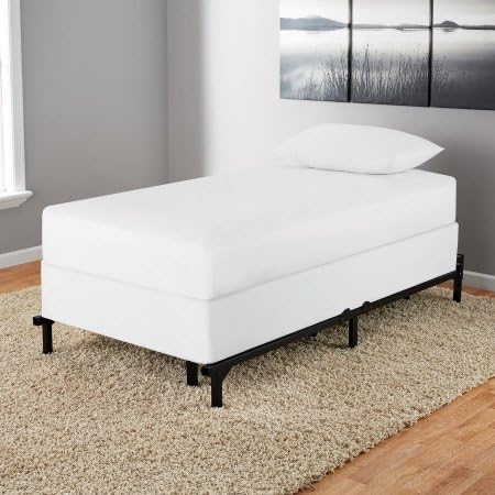 Assembled bed frame with a white box spring and mattress, ready for use.