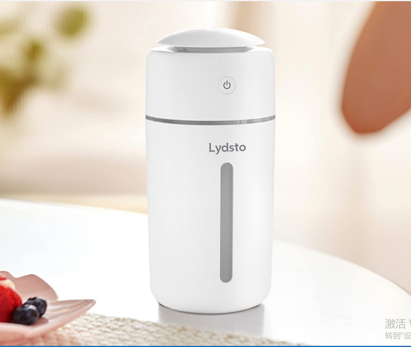 Lydsto Humidifier H1 on a bedside table with its warm night light on and mist gently rising.