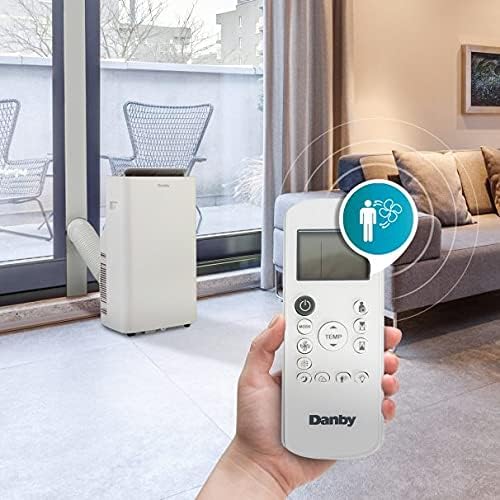 Hand holding remote control for Danby Portable Air Conditioner