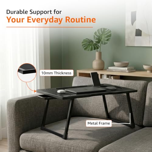 Image of Amazon Basics Engineered Wood Foldable Laptop Table with Cup and Pen Holder, Tablet and Mobile Phone Groove | Mini Drawer, Use for Writing, Bed, Breakfast (60L x 40W x 25H cm, Black)