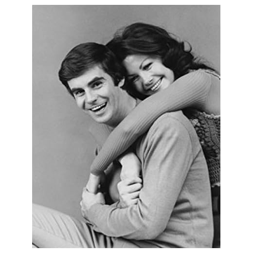 Young woman embracing a young man from behind Poster Print (18 x 24)