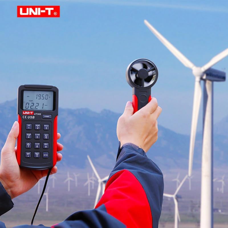 Person holding UNI-T UT361 Anemometer with fan sensor in an outdoor environment with wind turbines