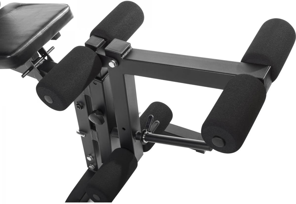 Close-up of the leg curl/extension pads and adjustment mechanism.