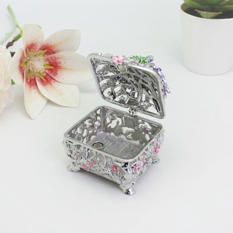 Open silver peacock jewelry box revealing the empty interior.