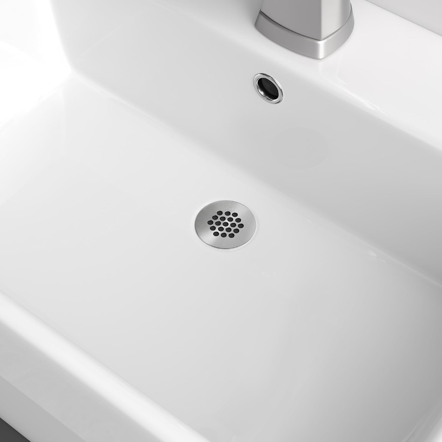 Jones Stephens D70-100 Commercial Lavatory Grid Drain installed in a white sink
