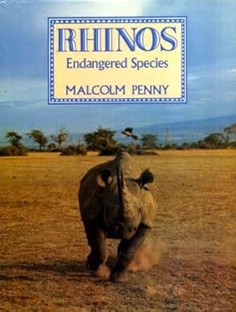 Paperback Rhinos: An Endangered Species (Invest in living) Book