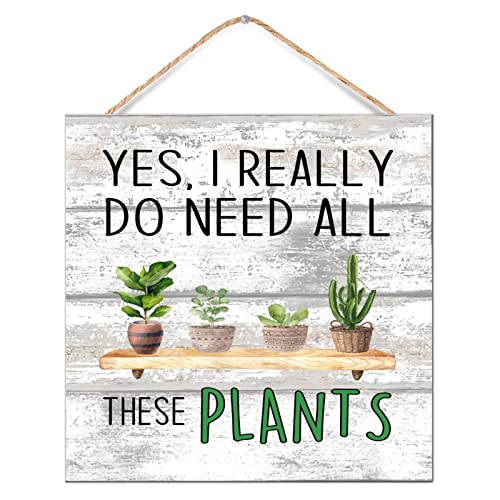 Inscription « Yes I Really Do Need All These Plants » sur panneau bois