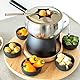 Mäser 931229 Fondue-Set 23-teilig, Edelstahl Fonduetopf inklusive Spritzschutz, Rechaud, Drehkarussell aus Holz, Fonduegabeln, Schälchen, Grau/Schwarz