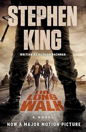 The Long Walk by Stephen King, depicting teenage boys walking on a road framed through the legs of a guard holding a gun.