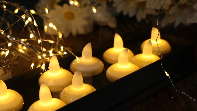 Image of 12 Pack Flameless Outdoor Waterproof LED Floating Tea Lights | Battery operated electric tealights, water-activated warm white flickering candles for wedding centerpiece pool decorations