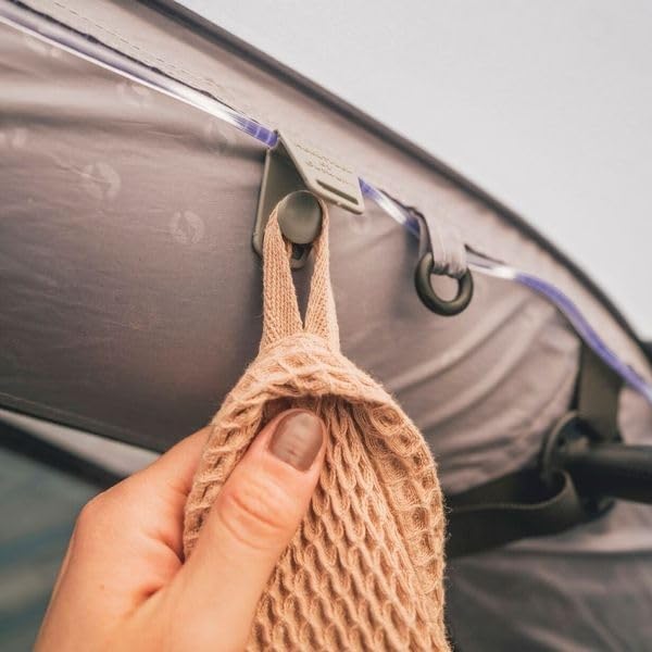 Hand hanging a towel on an internal tent hook