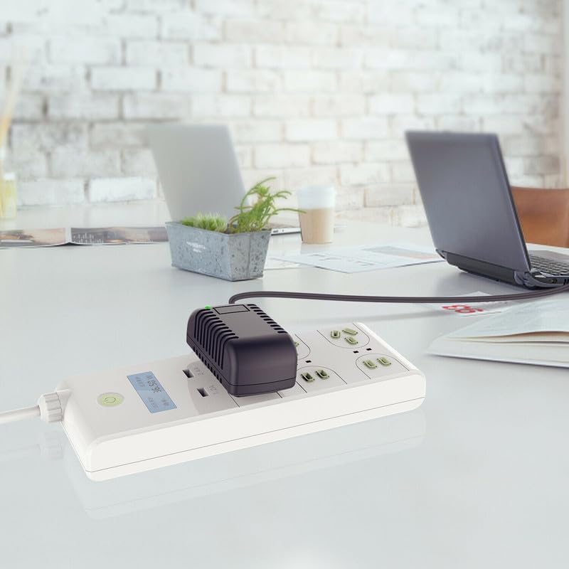 Pxdiiry AC/DC Adapter plugged into a white power strip, next to a laptop on a desk
