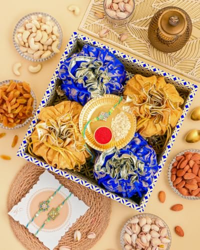 Image of Hyperfoods Rakhi for Brother with Dry Fruits Rawfruit's Handcrafted Potli Blue And Red with Thali Roli & Chawal Rakhi Gift Hamper for Brother Pack of 4 Cashew Almond Pistachios Raisins 495gm With Set of 3 Meena Rakhi