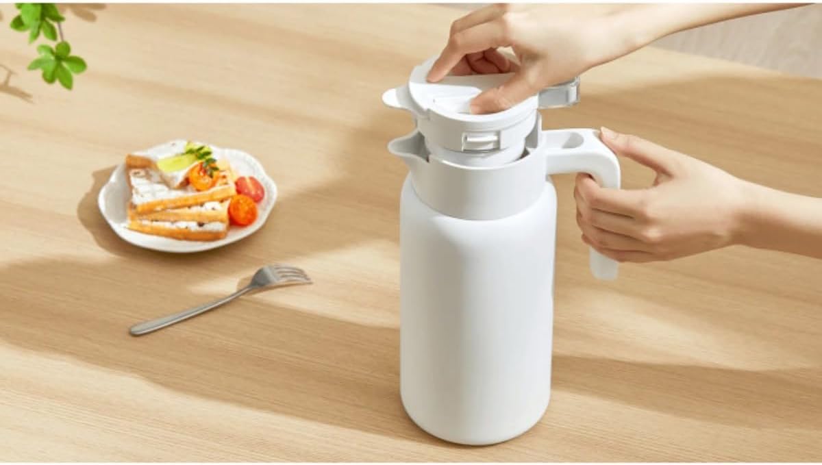 Hand opening the lid of the Xiaomi Insulated Kettle