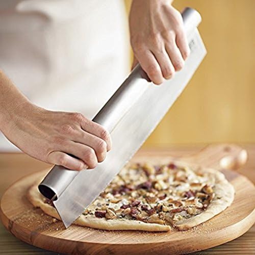 A person using the Bialetti 14-Inch Pizza Chopper to cut a pizza with mushrooms and other toppings on a round wooden board.