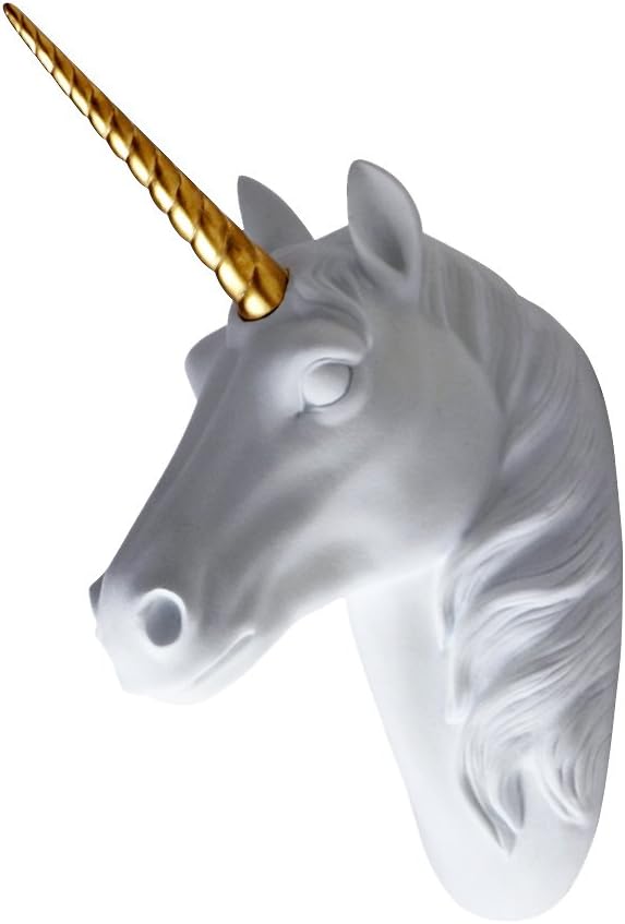Solid white unicorn bust on a wall with a shiny golden horn