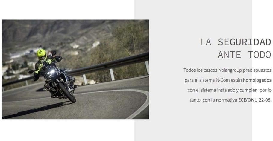 Motorcycle rider on a winding road, emphasizing safety with the communication system.