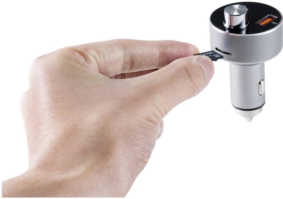 Hand inserting a Micro SD card into the side slot of the Renkforce RF-CAR-100 FM Transmitter