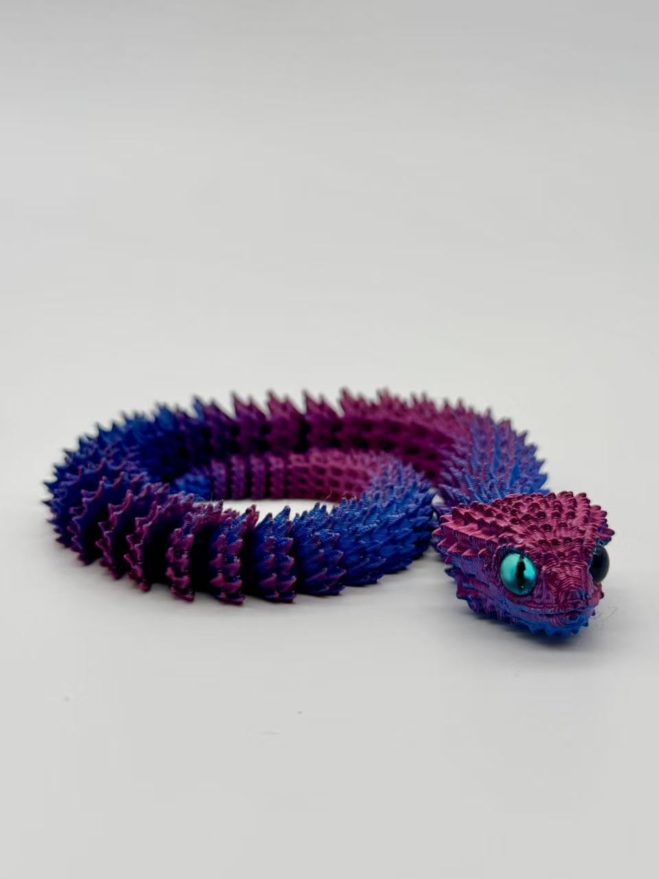 Celonix 3D Printed Snake Desktop Ornament with flexible body and vibrant purple and blue colors.