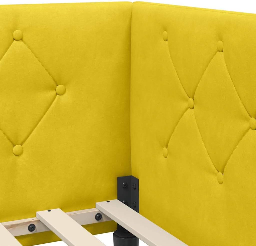 Close-up image of the yellow velvet fabric and tufted headboard detail of the bed frame.