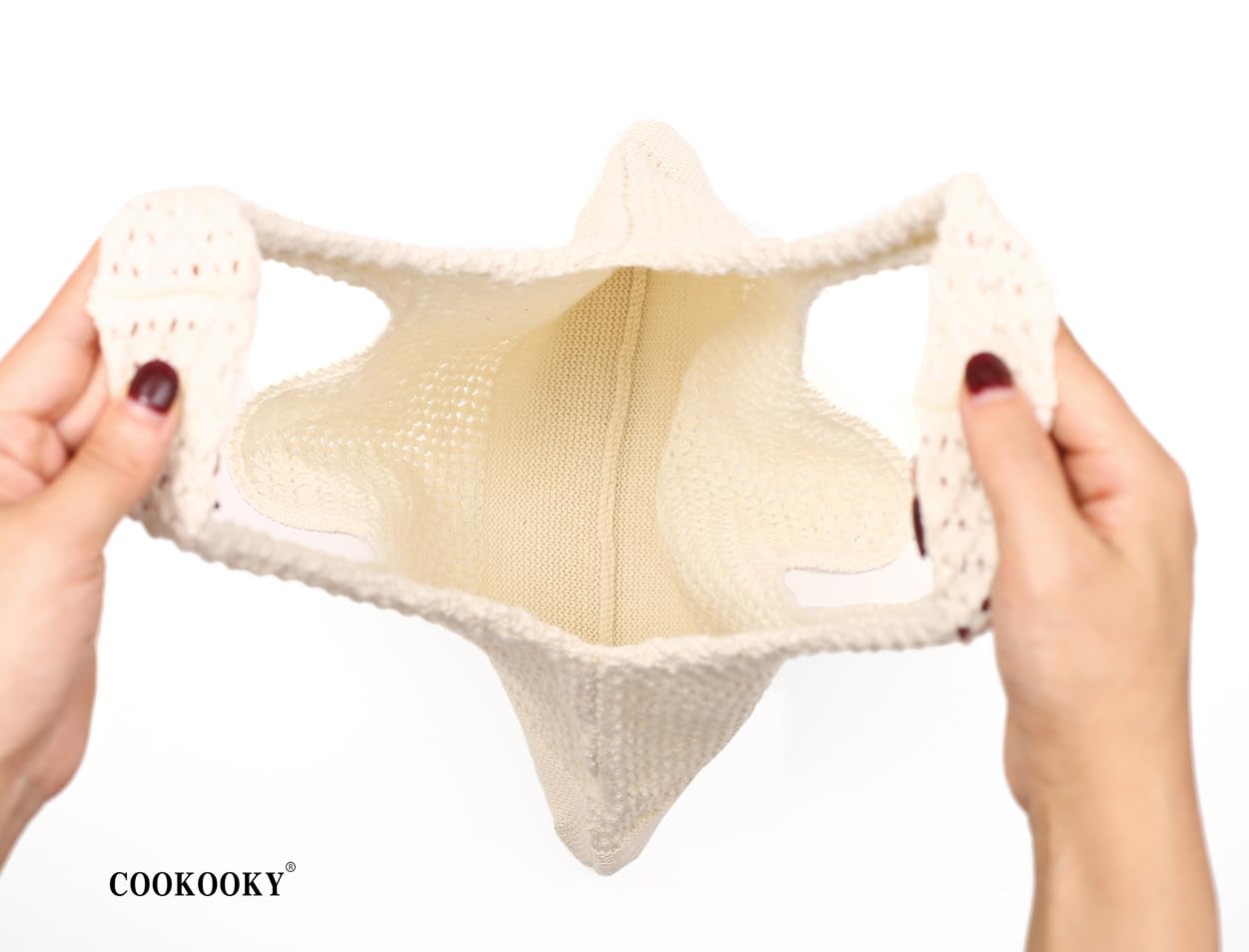 Close-up of the COOKOOKY Crochet Beach Tote's open weave and sturdy handle construction.