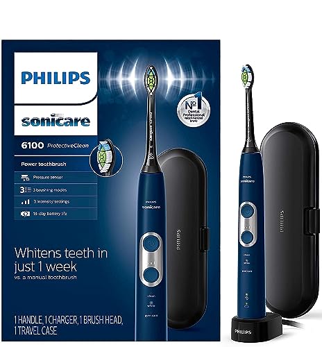 Philips Sonicare ProtectiveClean 6100 Rechargeable Electric Toothbrush in classic White finish (HX6877/33) standing on its charging base on a bathroom counter, the BrushSync brush head visible at the top, the visual pressure-indicator LED at the brush head neck illuminated to indicate the pressure-sensor monitoring, the digital intensity-level display on the handle, the Philips logo etched at the front of the chassis — the right pick for users with sensitive teeth, gum recession, recent dental work, or orthodontic appliances who want sonic technology with pressure-sensor protection at sub-$150