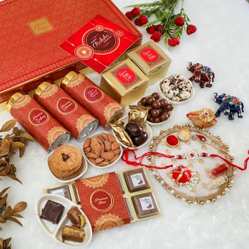 Image of NUTRISNACKSBOX Rakhi Gift Hamper Red for Brother & Bhabhi | 14 Items Premium Gift Box | Dry Fruits, Cookies, Chocolates, 2 Rakhis & Lumba