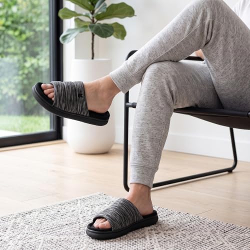 Man relaxing indoors in gray open-toe house slippers