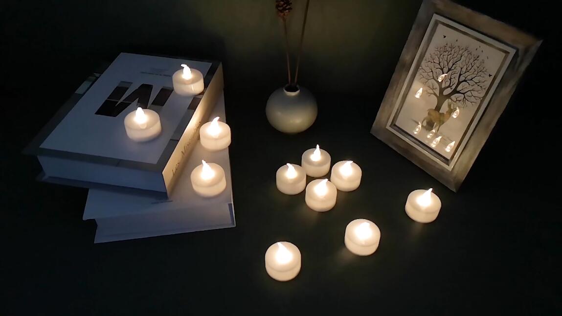 Image of YIWER Battery Tea Lights Candles Set of 24: Flickering flameless Realistic Tealights with Warm White Light Candle Light for Festivals Parties Halloween Warm Atmosphere (Pack of 3)