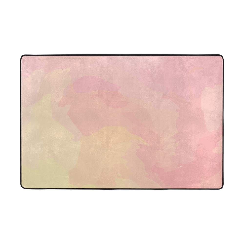 Tapis aquarelle rose corail pour créer un coin lecture cosy dans la chambre