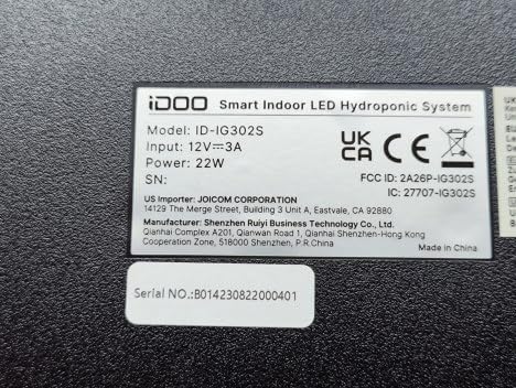 Close-up of the product label on the iDOO Smart Indoor LED Hydroponic System, showing Model: ID-IG302S, Input: 12V 3A, Power: 22W, and manufacturer details.