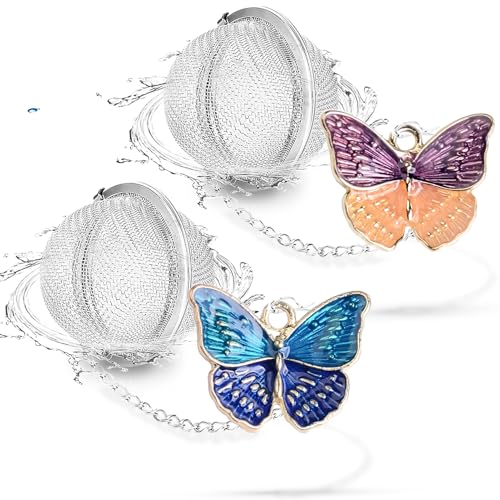 two butterfly-shaped stainless steel tea infusers on chains beside a mug