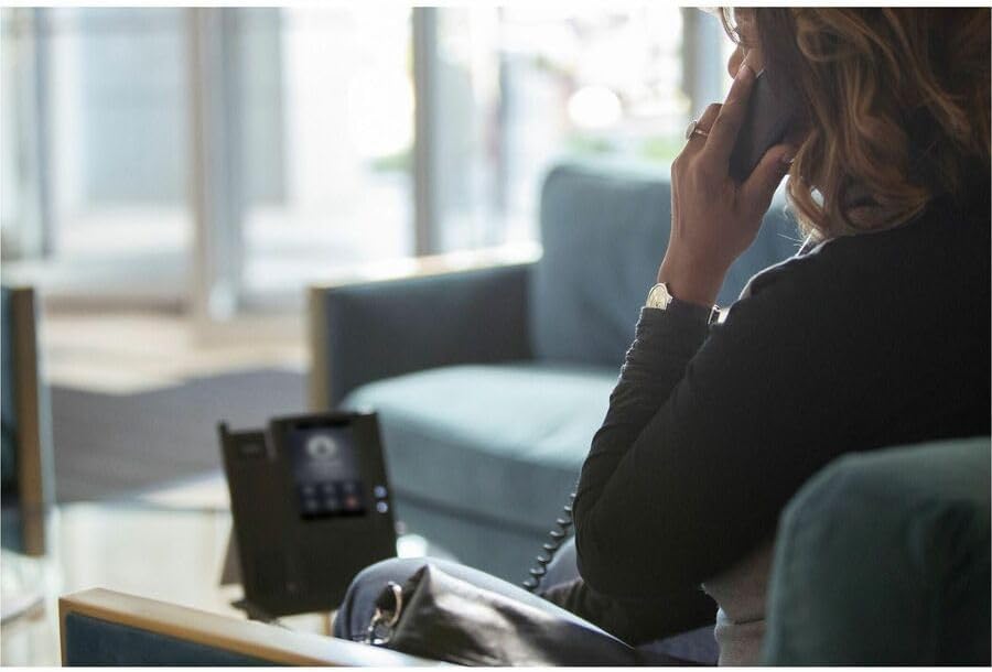 Person using the HP Poly CCX 400 IP Phone in an office setting
