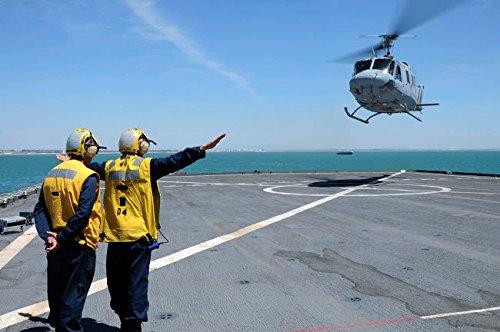 Airmen direct a Spanish navy AB-212 helicopter onto the flight deck of USS Gunston Hall Poster Print by Stocktrek Images (17 x 11)