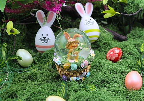 Dekohelden24 Schüttelkugel, Oster - Schneekugel, Schneekugel mit Osterhase, Osterhase im Korb, Osterkugel zum Schütteln, Hase mit bunten Blumen und Korb als Sockel, L/B/H 7 x 7 x 9 cm.