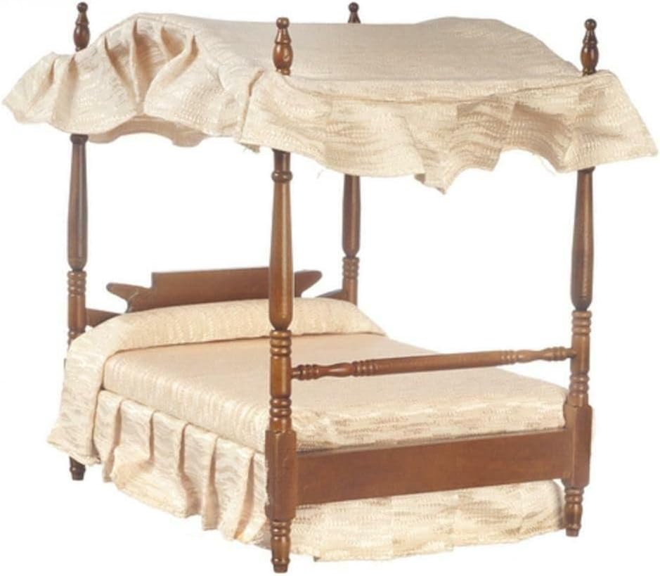 An ornate miniature canopy bed with pink drapes.