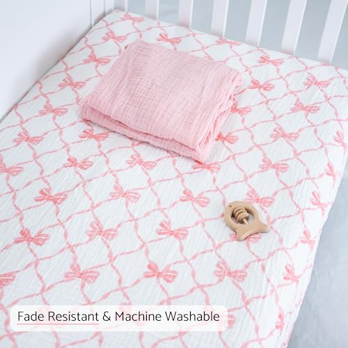 Image of LollyBanks Muslin Crib Sheet, 100% Cotton Fitted Crib Sheets for Girls | 2 Pack, Soft airy weave, flexible elastic hem on 52 x 28 in standard mattresses (Pink Bow and Solid Pink)