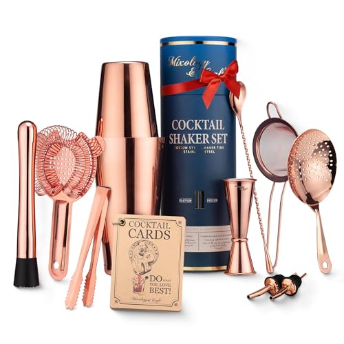 A copper-finish cocktail shaker set with strainer, jigger and bar spoon.
