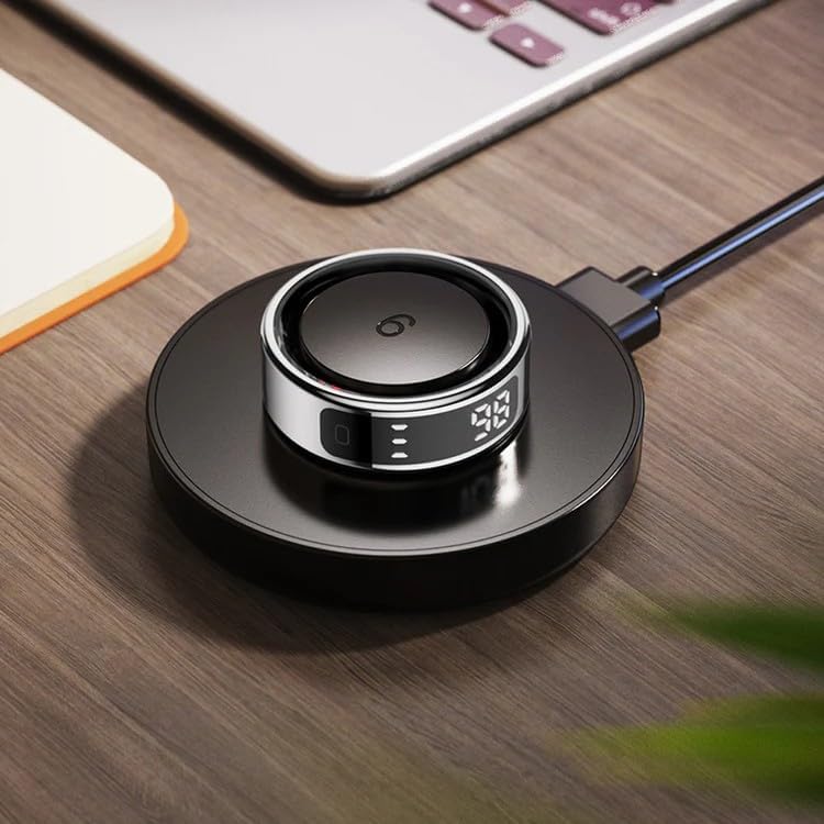 Colmi R12 Smart Ring placed on its wireless charging pad, connected via USB cable.