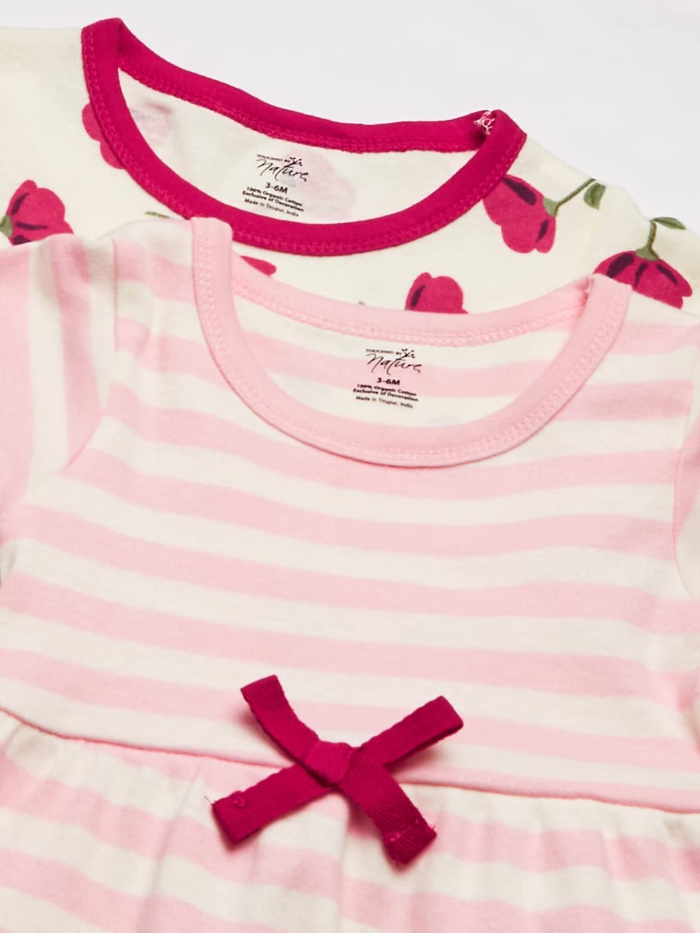 A child wearing a Touched by Nature organic cotton dress, showcasing its vibrant print and soft fabric.