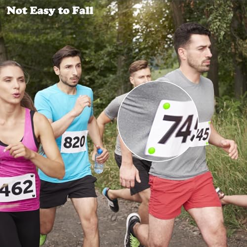 Runners wearing race number bibs secured to their shirts with circular magnetic fasteners.