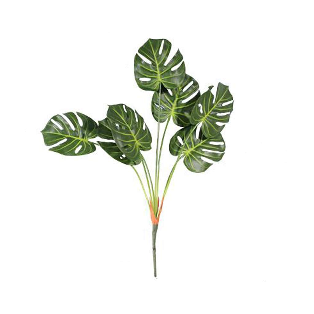 Feuille verte et fausse fleur tortue pour créer un salon tropical chaleureux