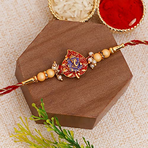 Image of eCraftIndia Golden, Red & Purple Lord Ganesha On Leaf Religious Rakhi, Wooden Cutout with Roli Chawal Pack - Rakhi for Brother, Bhaiya, Bhai