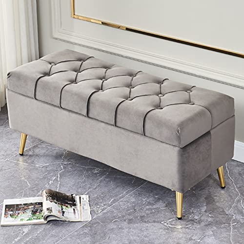 Pouf de rangement capitonné en velours gris avec finitions pieds dorés
