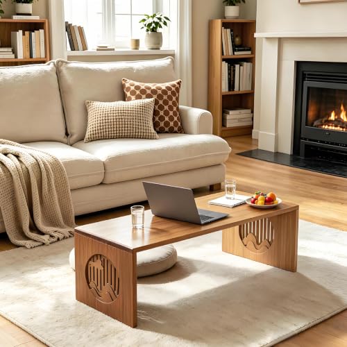 Foldable low wooden floor table used for coffee and a laptop in a warm living room.