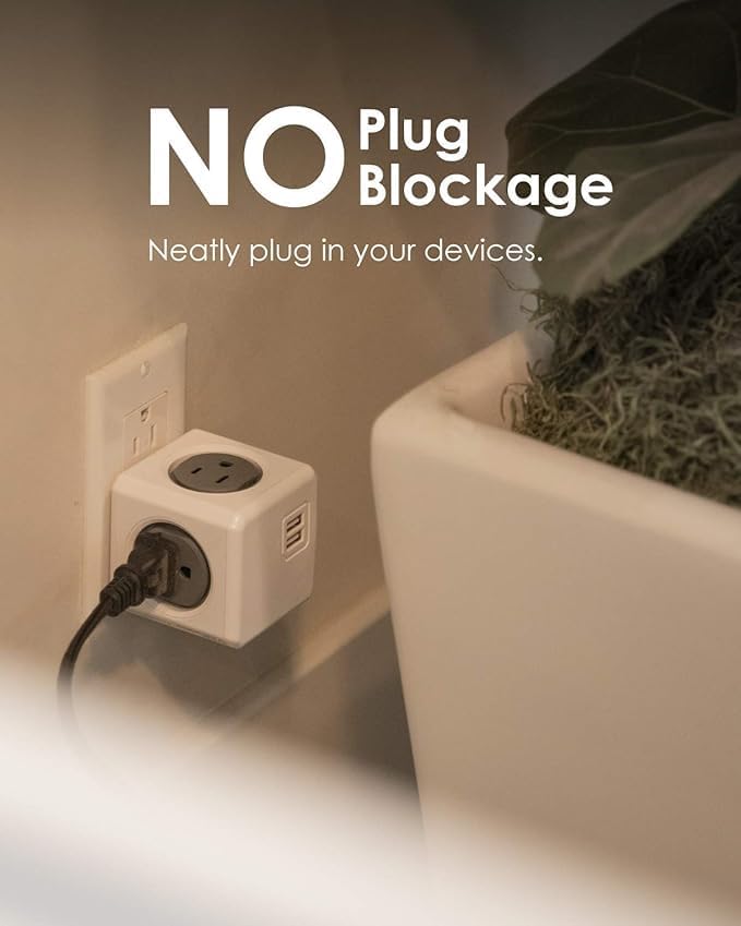 Allocacoc PowerCube Original USB plugged into a wall outlet with multiple devices connected, demonstrating no plug blockage