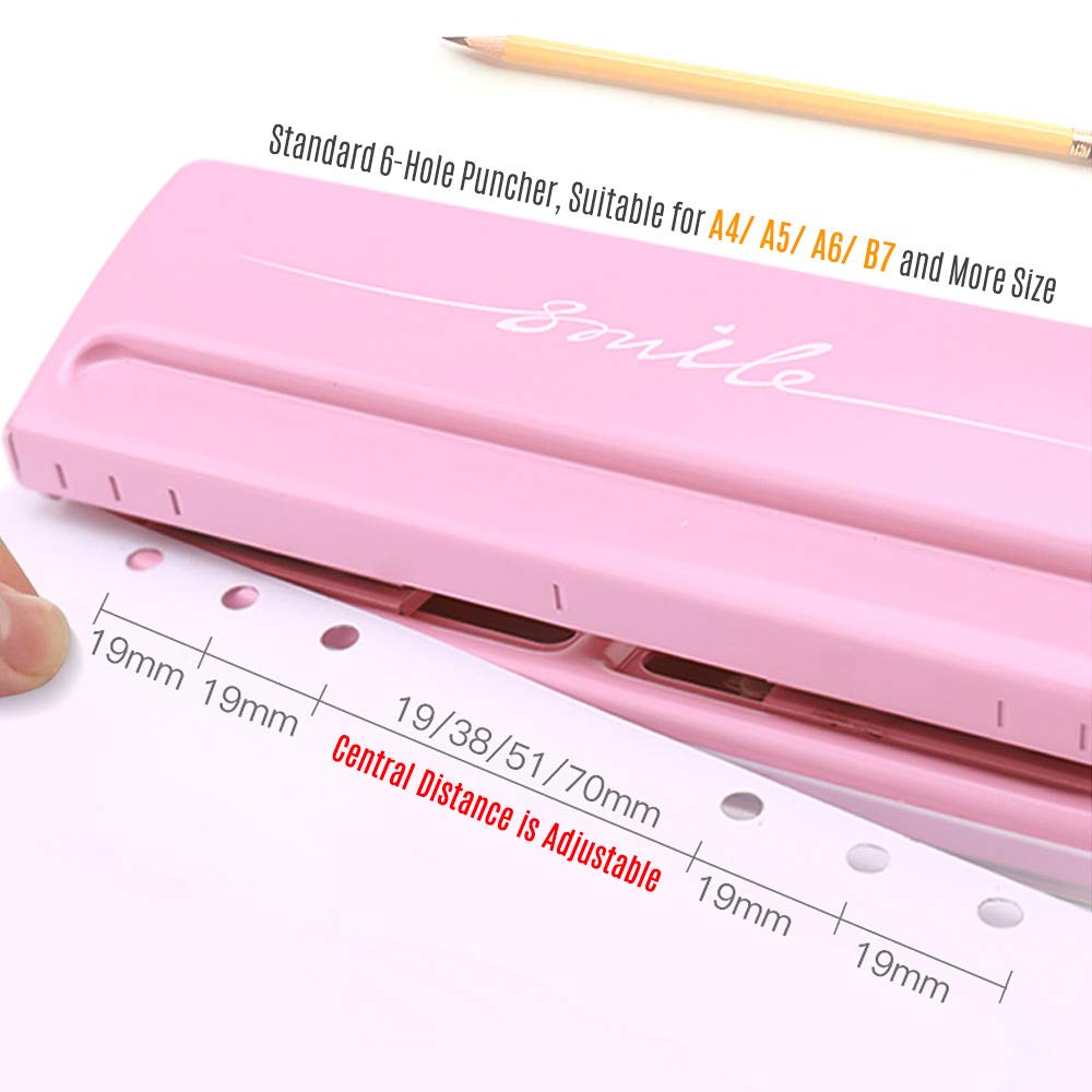 Pink 6-hole punch with a paper guide showing adjustable hole distances